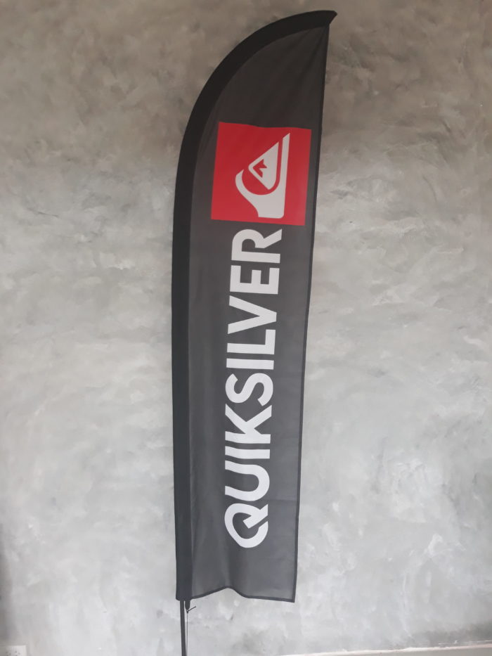 quiksilver black background beach flag with white content and red logo