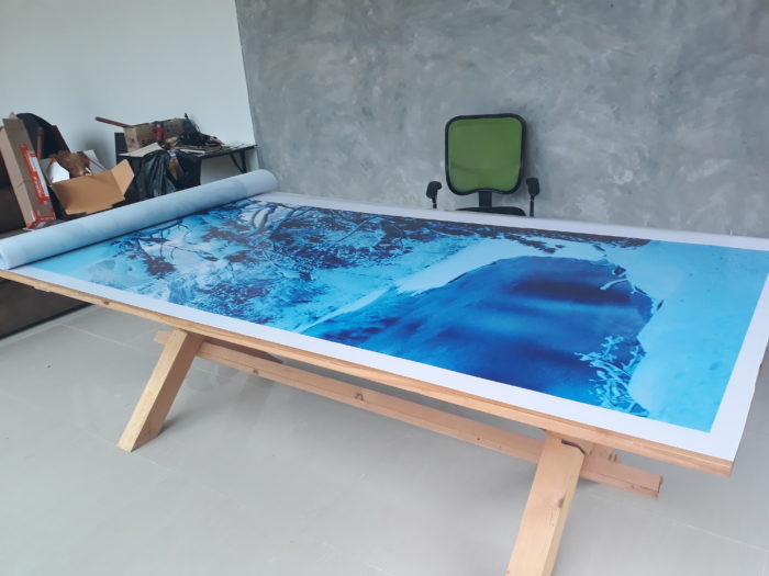 high quality backlit film print waiting cutting on office table