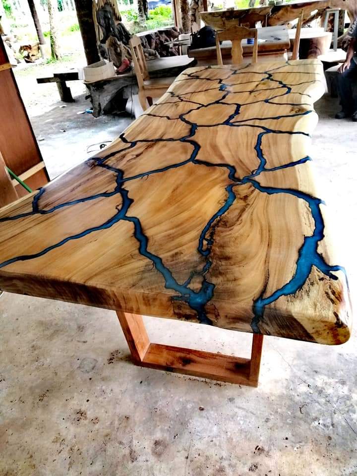 electric burn holes in wood are filled blue epoxy resin with stunning results
